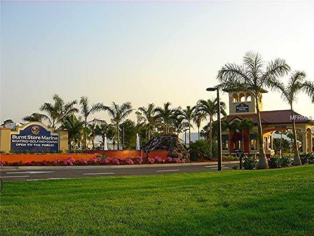 Marina com placa indicando 'Burnt Store Marina', oferecendo serviços de navegação, golfe e gastronomia.