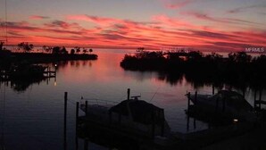 A marina at sunset with calm water and docked boats. - GOLF  BOATING BIKING (Punta Gorda)