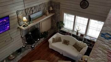 TV connectée, cheminée, livres, chaßne hi-fi