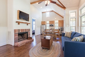 Relax in this inviting living area with a brick fireplace, comfortable sofa, and woven rug.
