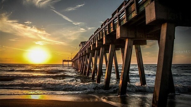 A pier extending into the ocean with the sun setting in the background. - IMMACULATE 3BR 2 BATH PRIVATE POOL HOME MINUTES TO BEACHES, DOWNTOWN.  (Venice)