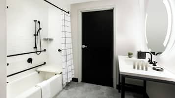 Un baño moderno con bañera, inodoro, ducha y lavabo.
