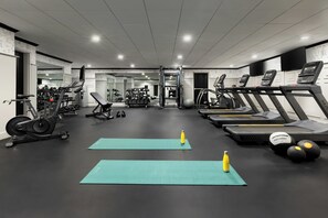 A gym with treadmills, elliptical machines, and free weights. - Arcadian Hotel (Brookline)