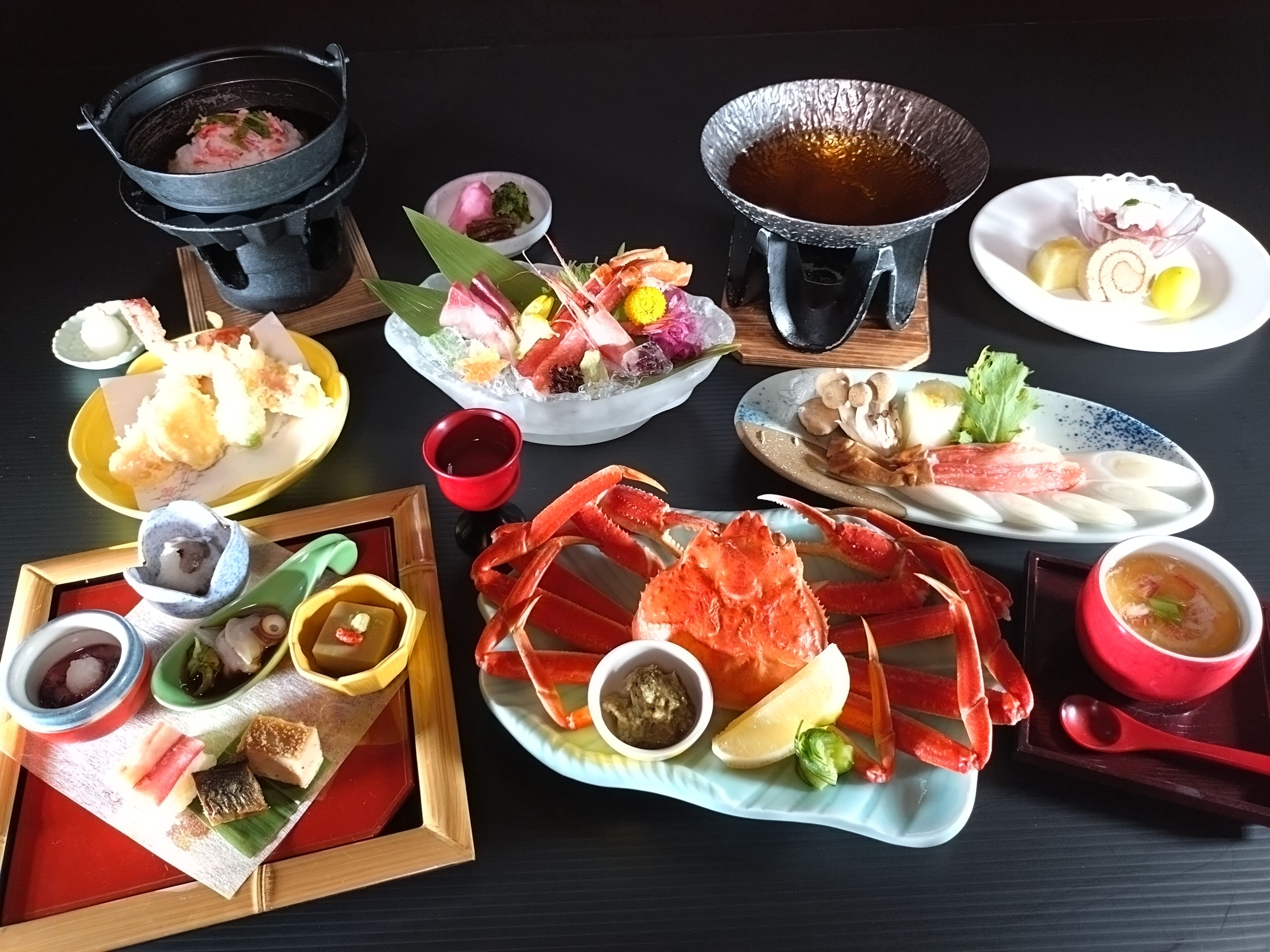 A variety of dishes and food items on a table, including seafood, vegetables, and condiments.