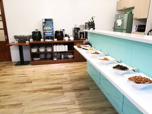 A buffet area with various food items and a coffee station. - Oak Garden Hotel (Hualien City)