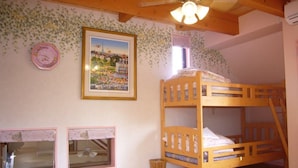 A bunk bed room with a ceiling fan, a framed picture on the wall, and a window with a curtain. - Heart Land Hills Fairy tale house (Shika)
