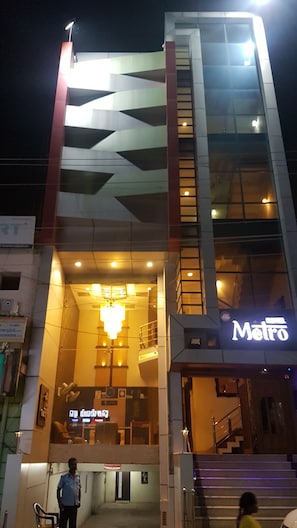 A hotel with a modern design, featuring a prominent staircase and a sign that reads "Metro". - Hotel Metro (Kumbakonam)