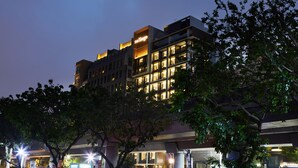 A multi-story hotel with illuminated signage and a modern architectural design. - The Tango Taipei Jiantan (Taipei)