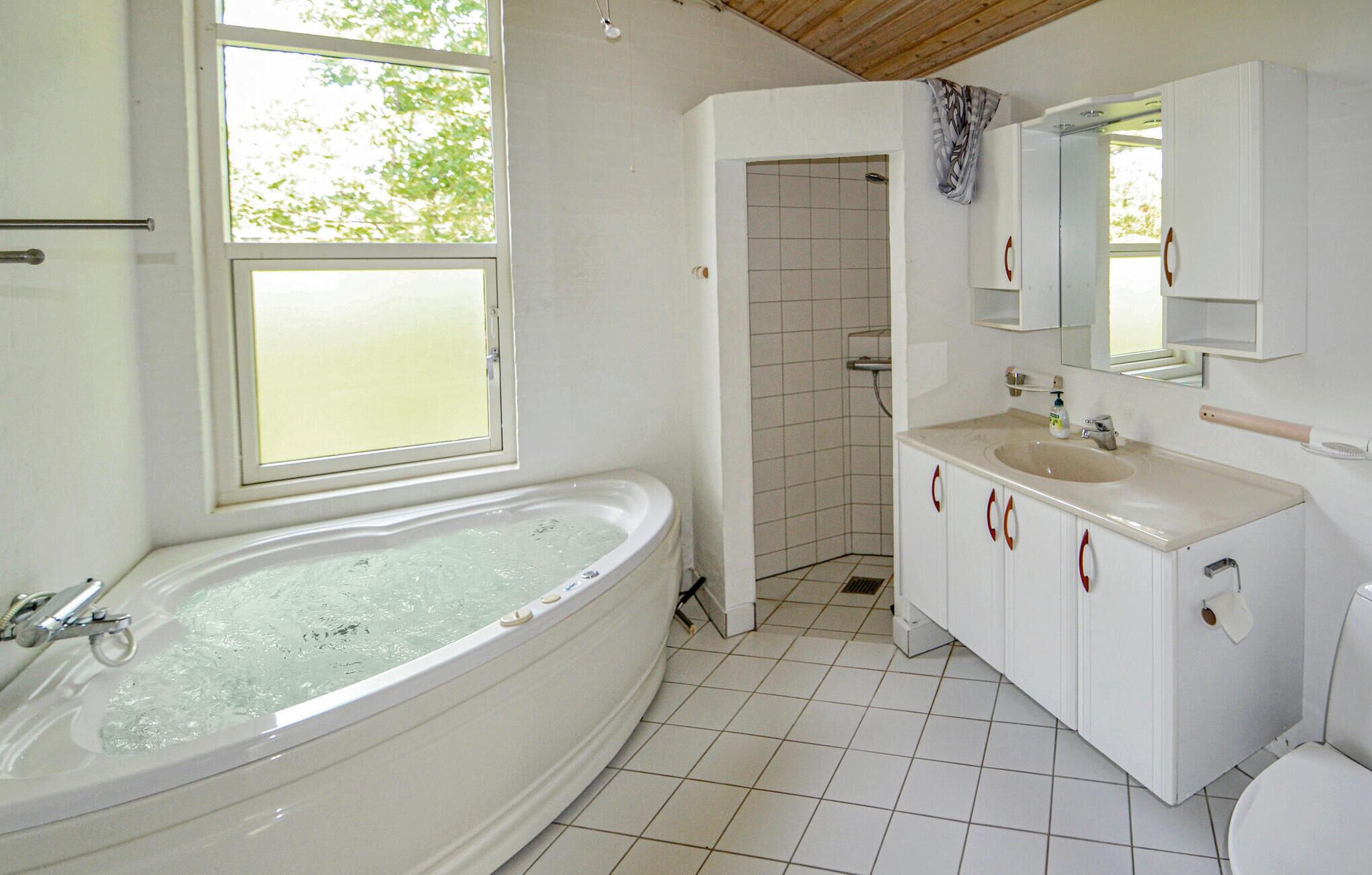 A bathroom with a bathtub, a sink, and a toilet.
