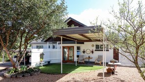 A house with a covered patio, a lawn, and a fenced backyard. - Arbour1 (George)