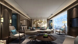 A modern hotel room with a sectional sofa, armchairs, a coffee table, and a flat-screen TV. - Primus Hotel Nanchang International Expo City (Nanchang)
