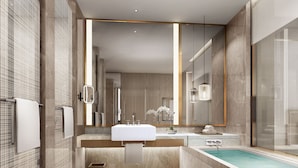 A modern bathroom with a large mirror, two sinks, a bathtub, and a small window. - Primus Hotel Nanchang International Expo City (Nanchang)