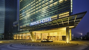 A modern hotel building with a prominent sign reading "PRIMUS HOTEL" and a well-lit entrance. - Primus Hotel Nanchang International Expo City (Nanchang)