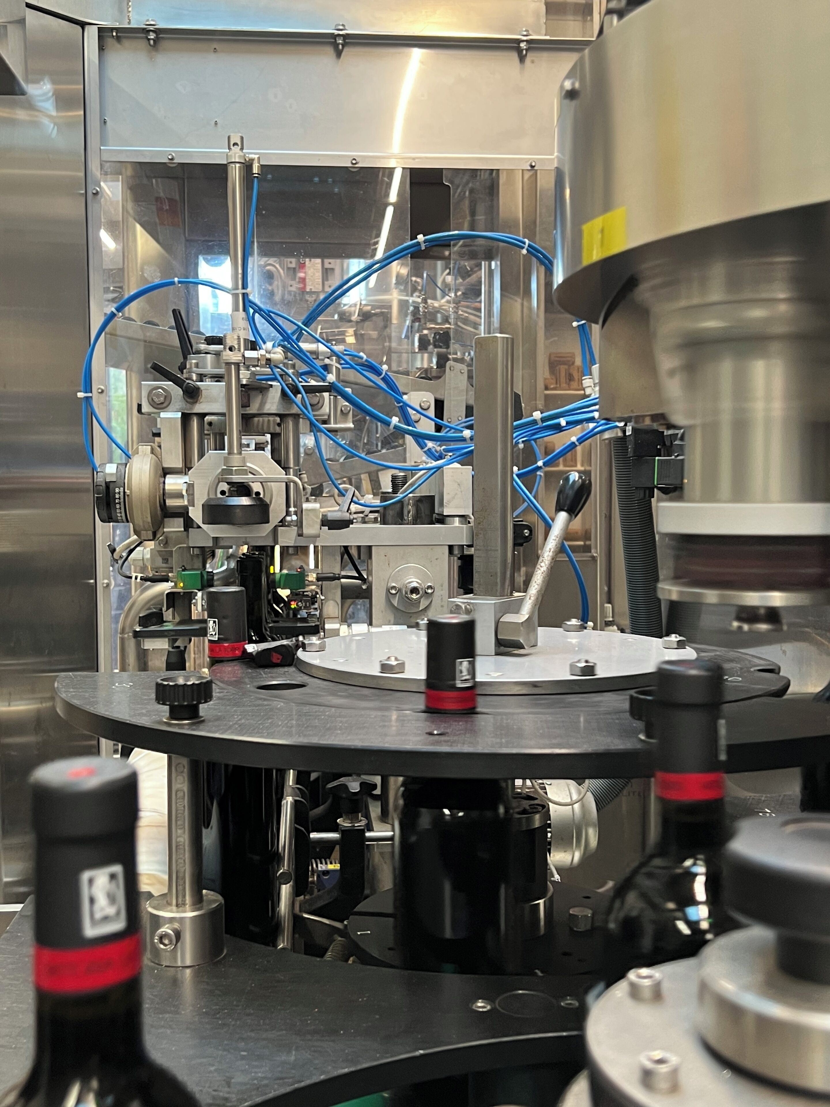 A complex industrial machine with multiple components and blue cables.