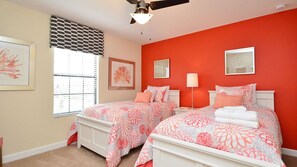 A bedroom with two beds, a ceiling fan, and artwork on the walls. - Grhrfd1467 - Champions Gate Resort - 6 Bed 6 Baths House (Davenport)