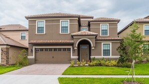 A two-story house with a brown facade, a front garage, and a well-maintained lawn. - Grhrfd1469 - Champions Gate Resort - 9 Bed 5 Baths House (Davenport)