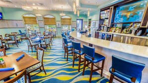 A hotel lobby with a bar area, seating arrangements, and a patterned carpet. - Grhmvd1496 - Champions Gate Resort - 8 Bed 5 Baths House (Davenport)