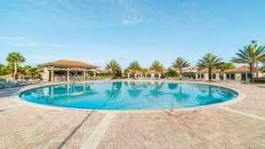 A swimming pool with a tiled deck, surrounded by palm trees and lounge chairs. - Grhmvd1700 - Champions Gate Resort - 9 Bed 5 Baths House (Davenport)