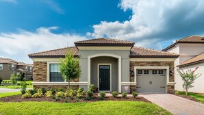 A residential house with a stone facade, a tiled roof, and a front entrance. - Grhwgd9165 - Champions Gate Resort - 4 Bed 3 Baths House (Davenport)
