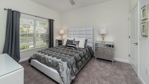 A bedroom with a bed, two bedside tables, a nightstand, a window with curtains, and a door. - Grhmvd1595 - Champions Gate Resort - 4 Bed 3 Baths Townhouse (Davenport)