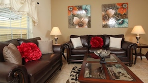 A living room with two sofas, a coffee table, and two wall-mounted lamps. - Grhbch3043 - Paradise Palms Resort - 4 Bed 3 Baths Townhouse (Kissimmee)