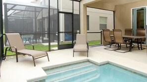 An outdoor swimming pool area with lounge chairs and a table. - Grhcap8858 - Paradise Palms Resort - 6 Bed 5 Baths House (Kissimmee)
