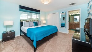 A bedroom with a bed, bedside tables, a dresser, a mirror, and a view of the outside. - Grhcap8929 - Paradise Palms Resort - 4 Bed 3 Baths Townhouse (Kissimmee)