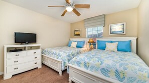 A bedroom with two beds, a TV, a ceiling fan, and a dresser. - Grhcup8968 - Paradise Palms Resort - 4 Bed 3 Baths Townhouse (Kissimmee)
