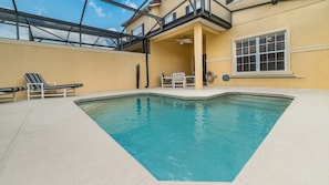 An indoor swimming pool with a glass ceiling, lounge chairs, and a table. - Grhcpr8971 - Paradise Palms Resort - 4 Bed 3 Baths Townhouse (Kissimmee)