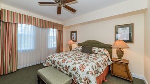 A hotel room with a large bed, a bench, two bedside lamps, and a ceiling fan. - Grhhc7661-201 - Reunion Resort - 3 Bed 2 Baths Condo (Kissimmee)