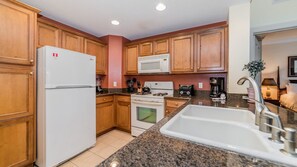 Family Condo, Kitchen, Garden Area | Shared kitchen | Fridge, microwave, oven