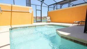 An indoor swimming pool with clear water, surrounded by yellow walls and a glass enclosure. - Grhbch3069 - Paradise Palms Resort - 4 Bed 3 Baths Townhouse (Kissimmee)