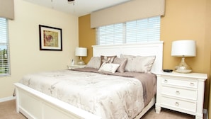 A bedroom with a bed, nightstands, and a window with blinds. - Grhmap8980 - Paradise Palms Resort - 5 Bed 4 Baths Townhouse (Kissimmee)