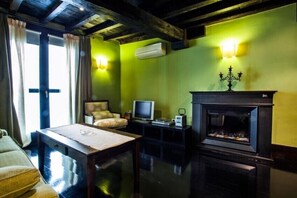 Monolocale Deluxe | Area soggiorno | TV a schermo piatto, caminetto, lettore DVD