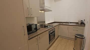 1-Bedroom Luxury Apartment | Private kitchen | Full-size fridge, microwave, oven, stovetop