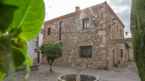 Un edificio de piedra con una fuente en el patio.