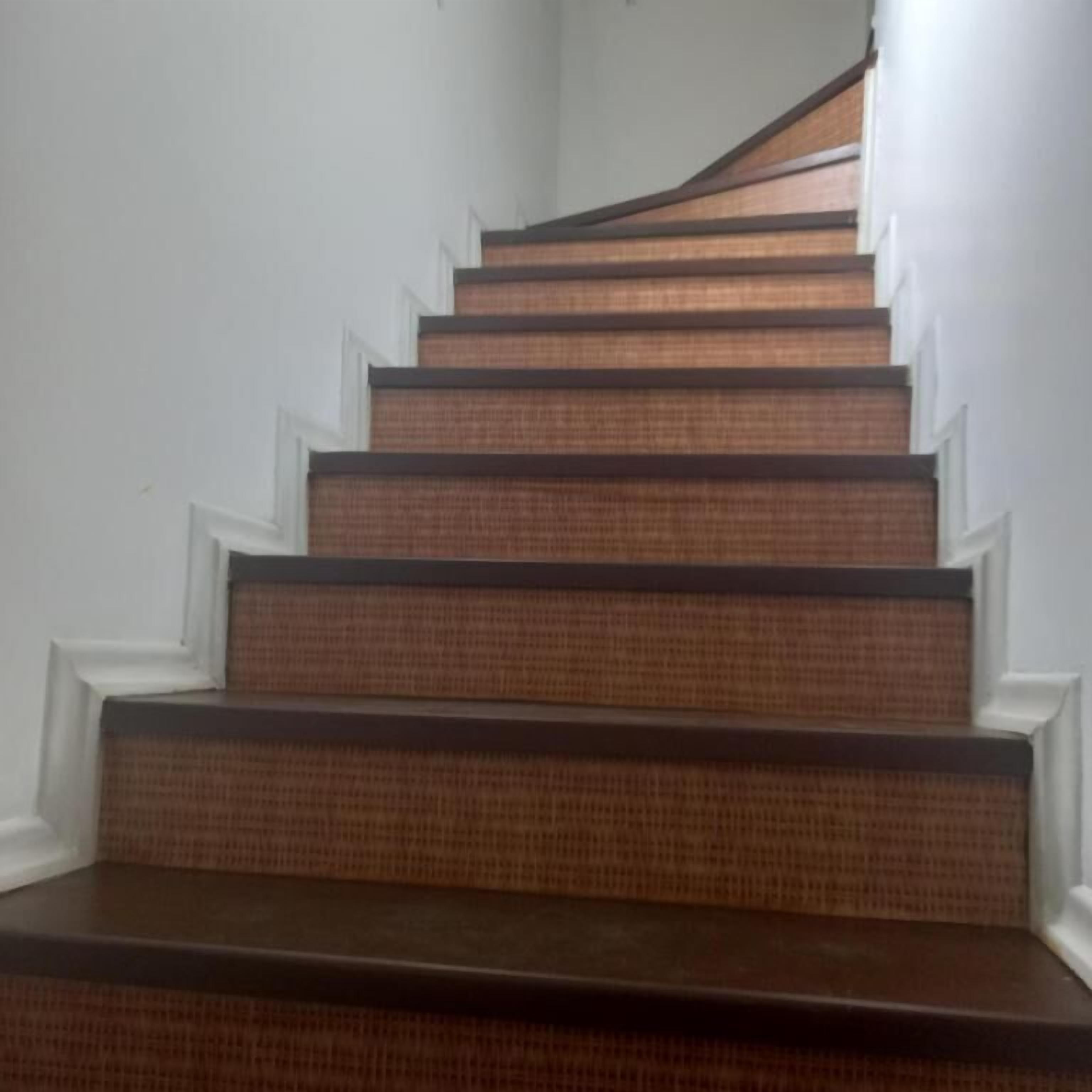 A staircase with wooden steps and white trim.