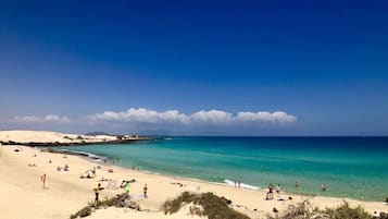 On the beach, sun-loungers