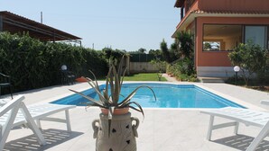 A swimming pool with white lounge chairs and a decorative pot in the center. - HOME RELAX: NATURE, GOOD FOOD FOLKLORE (Balestrate)