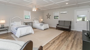 A bedroom with two beds, a ceiling fan, a star decoration, and a television. - Oak Knob Equestrian Home (Campobello)