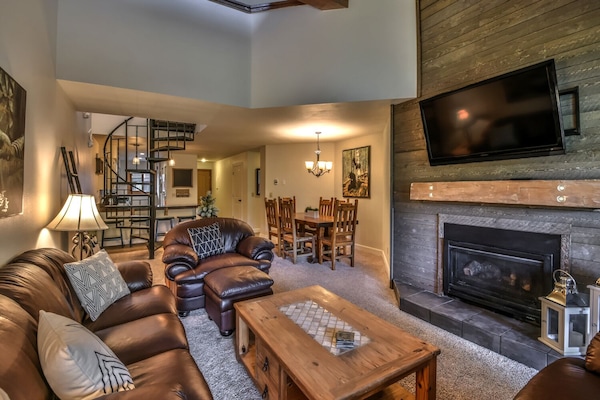 Open concept living/dining area with flat screen TV and fireplace