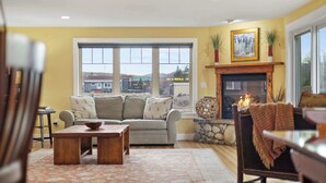 A cozy living room with a sofa, coffee table, and fireplace. - Tight Lines (Red Lodge)
