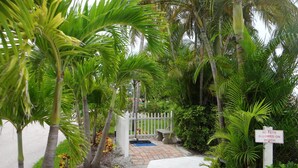 A pathway leading to a gated area with a sign prohibiting pets on the beach. - Lovers Key Beach Club by Lovers Key Vacations (Fort Myers Beach)