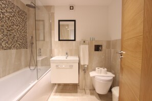 Family Apartment, 3 Bedrooms | Bathroom | Combined shower/tub, free toiletries, hair dryer, towels