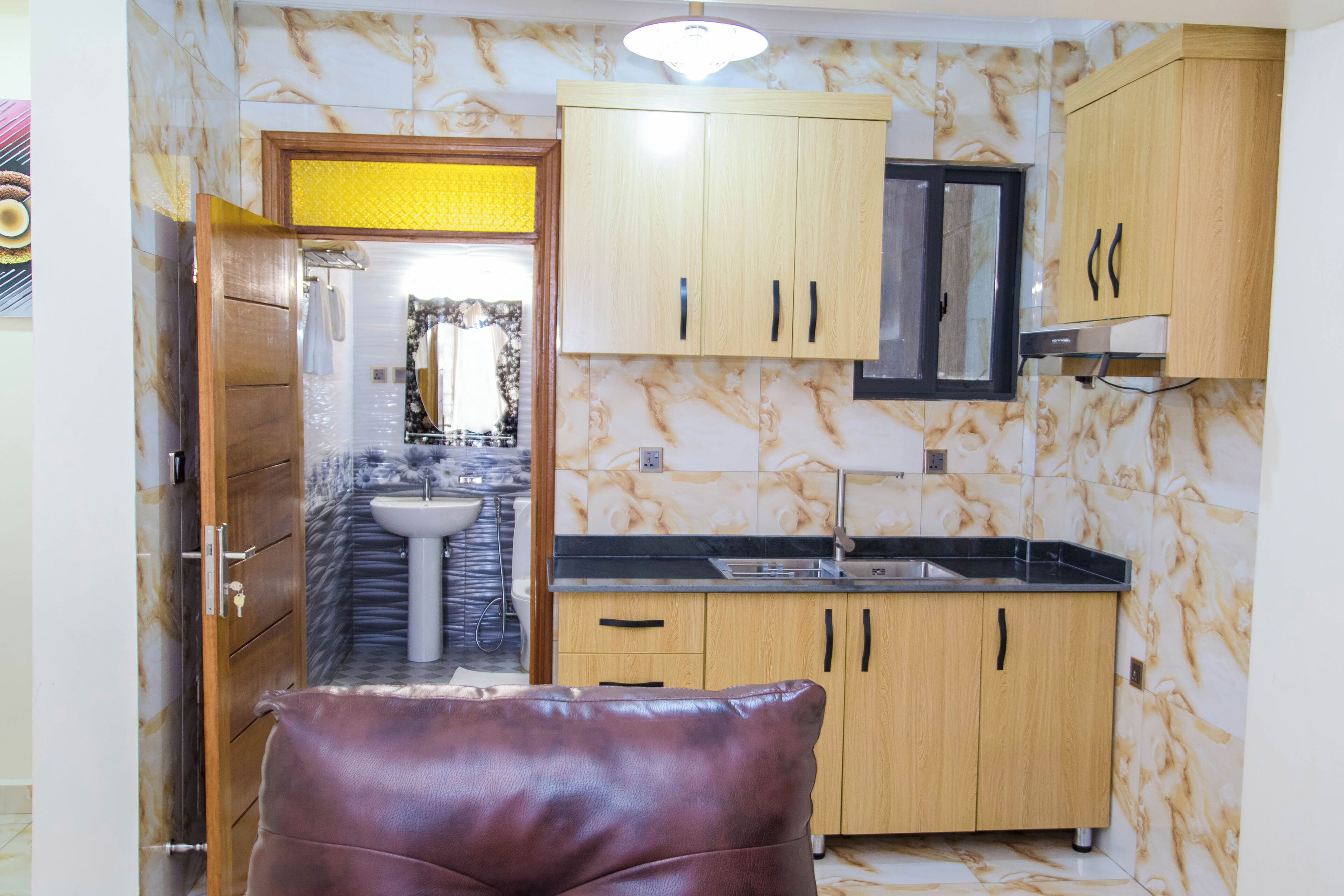 A kitchen with wooden cabinets, a sink, and a countertop.