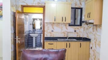 A kitchen with wooden cabinets, a sink, and a countertop.