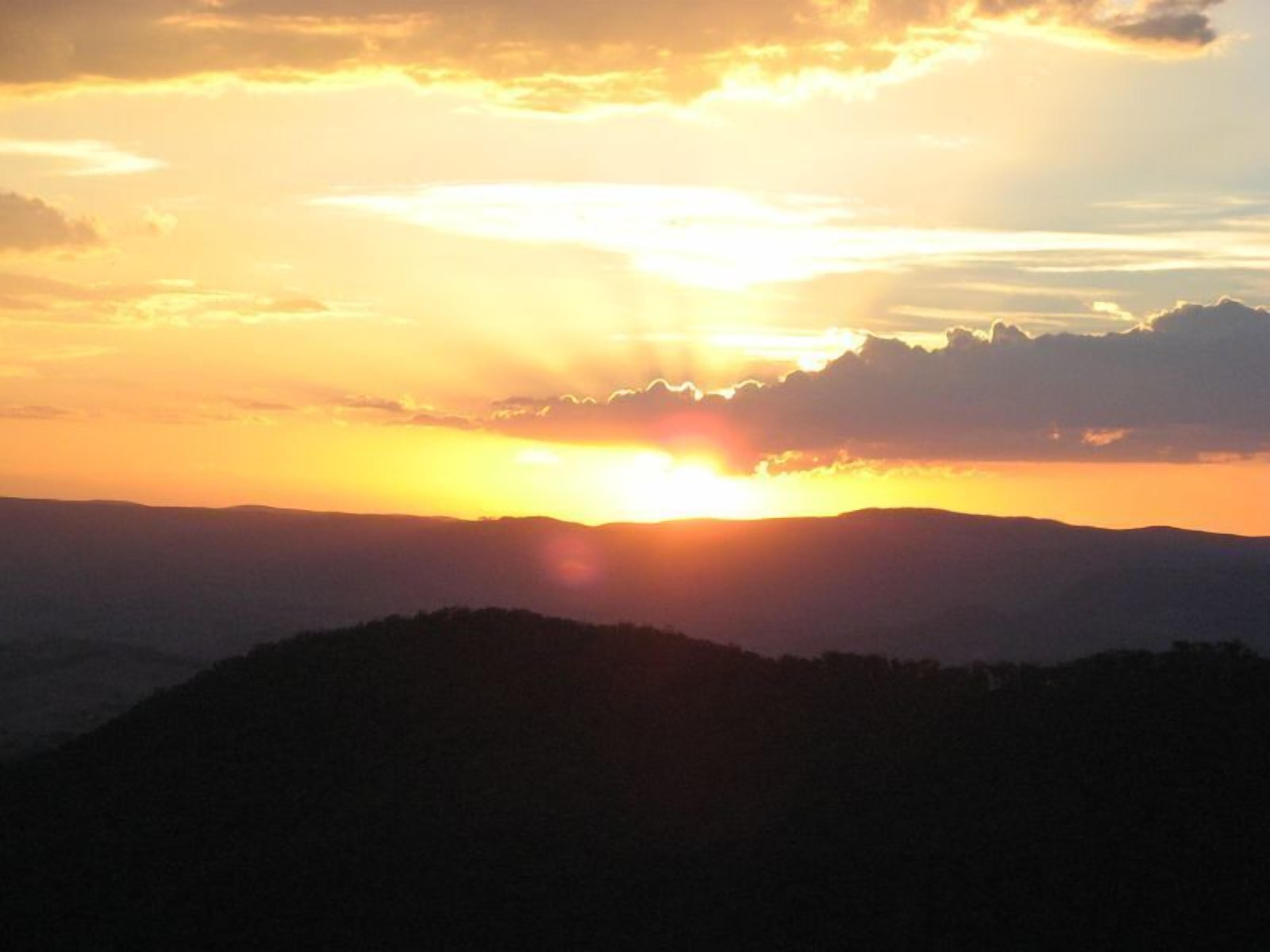 A sunset over a mountainous landscape.