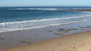 A beach with waves, a clear sky, and a sandy shore. - Fitzgerald Cape Paterson (Cape Paterson)