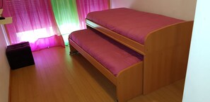 Cozy retreat with a bunk bed featuring two levels, perfect for sharing with a friend.