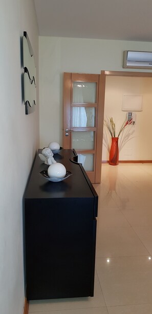 Experience a serene retreat with a sleek console table, entrance, and natural touches.
